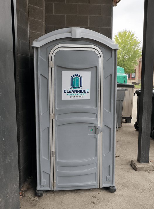 Cleanridge portable toilet stationed at the rear of a commercial building