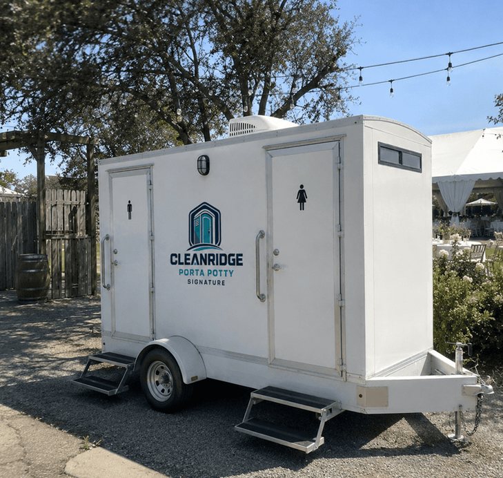 Cleanridge restroom trailer positioned at an outdoor wedding venue