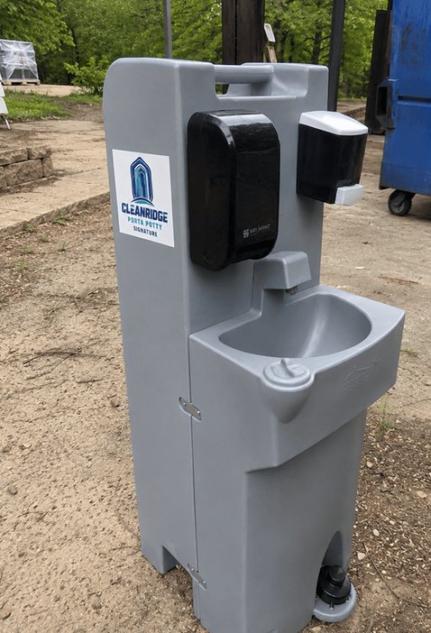 Portable sink station set up beside a park path