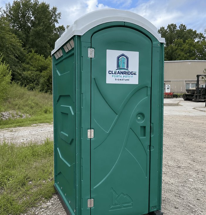 Cleanridge portable toilet placed at the edge of a work yard