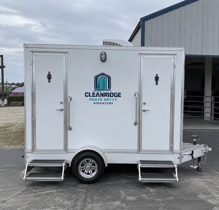 Two stall Cleanridge restroom trailer parked outside an event venue
