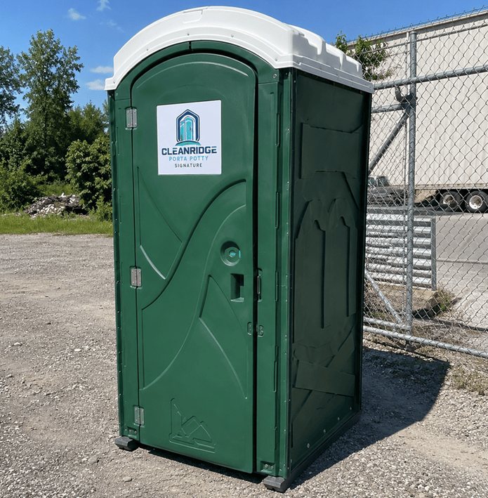 Standard Cleanridge portable toilet unit set on a gravel yard